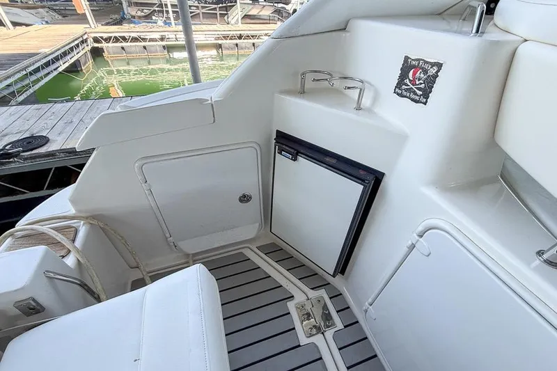 Slide: The Image of 2006 Regal 3060 Window Express boat interior with seating and mini fridge. - 18