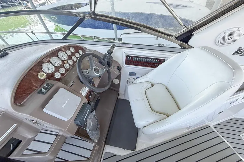 Slide: The Image of Cockpit of 2006 Regal 3060 Window Express boat with steering wheel and gauges. - 20