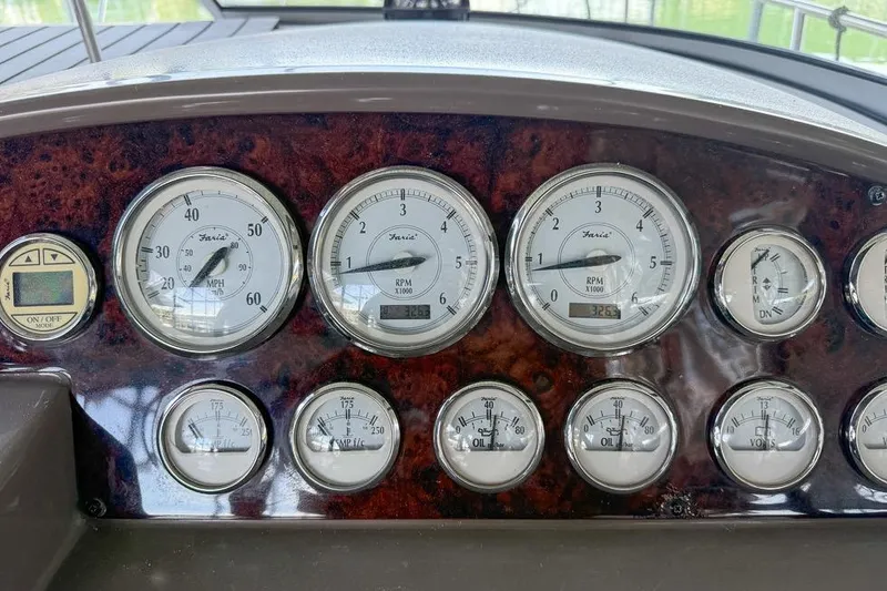 Slide: The Image of Dashboard of a 2006 Regal 3060 Window Express boat with various gauges and controls. - 23