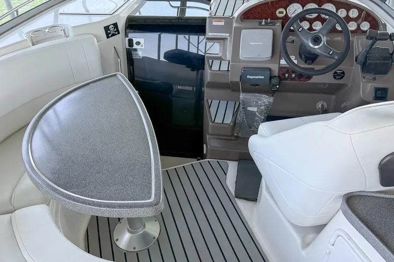 Slide: The Image of Interior of a 2006 Regal 3060 Window Express boat with steering wheel and seating area. - 29