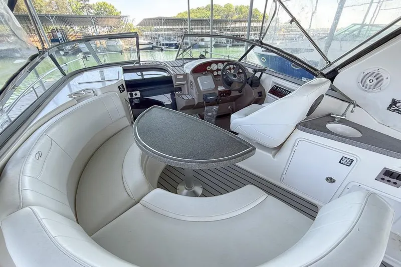 Slide: The Image of 2006 Regal 3060 Window Express boat interior with seating, table, and helm. - 3