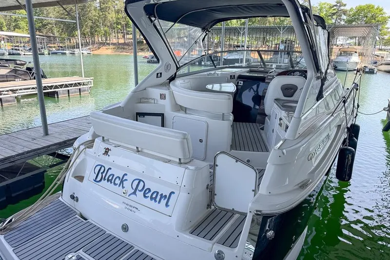 Slide: The Image of 2006 Regal 3060 Window Express boat named "Black Pearl" docked at a marina. - 4