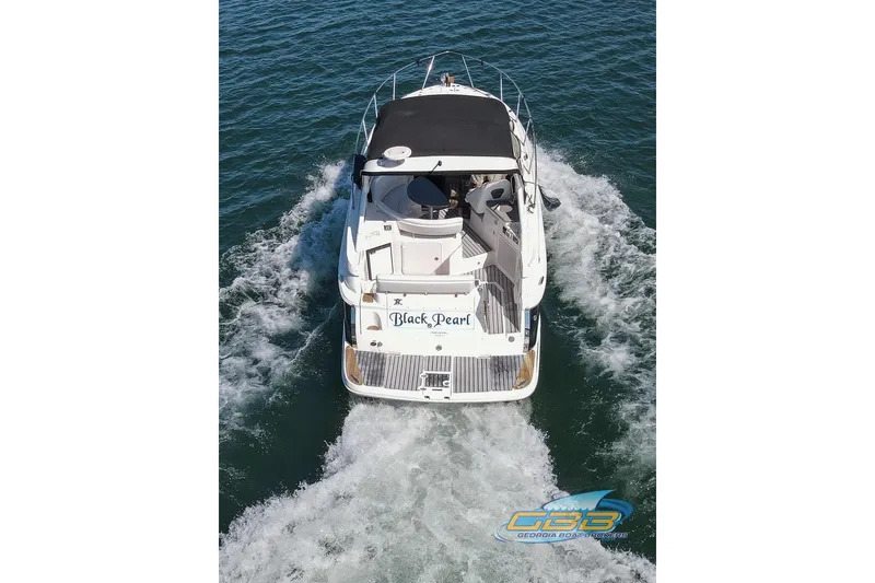 Slide: The Image of 2006 Regal 3060 Window Express boat cruising on open water, rear view. - 5