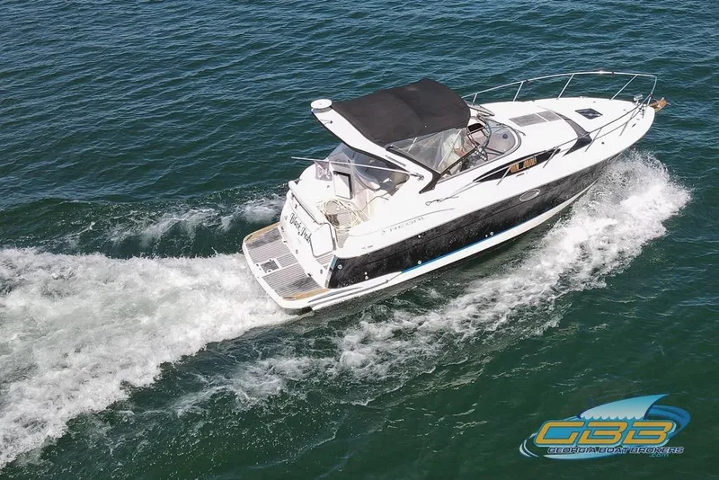 Slide: The Image of 2006 Regal 3060 Window Express cruising on open water, aerial view. - 6