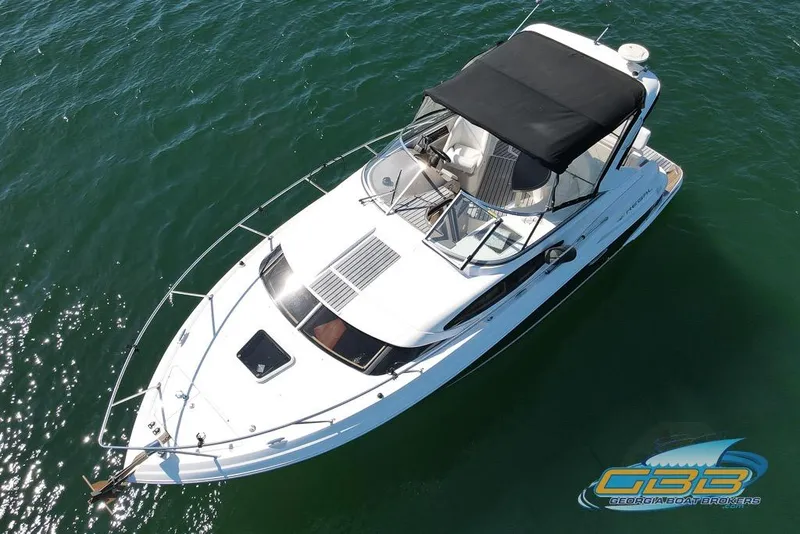 Slide: The Image of 2006 Regal 3060 Window Express boat with black canopy on calm water. - 7