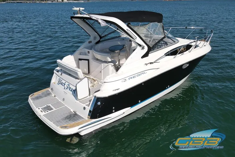 Slide: The Image of 2006 Regal 3060 Window Express boat on water, featuring sleek design and spacious deck. - 8