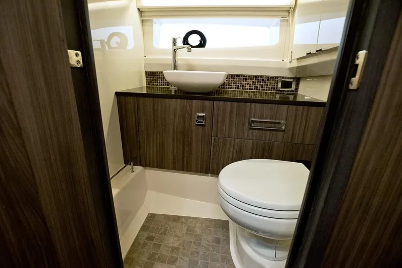 Slide: The Image of Manufacturer Provided Image: Modern bathroom in 2021 Sea Ray SLX 400 boat with sink and toilet. - 12