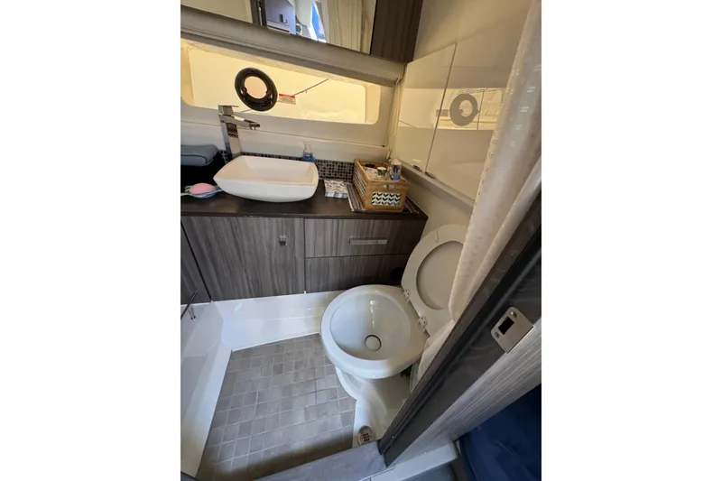 Slide: The Image of Modern bathroom interior of 2021 Sea Ray SLX 400 yacht, featuring sink and toilet. - 13