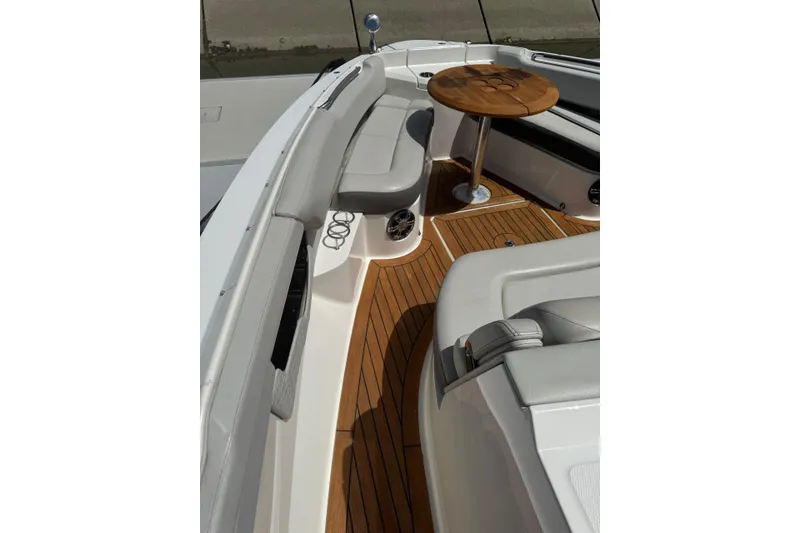 Slide: The Image of Luxurious 2021 Sea Ray SLX 400 boat interior with elegant seating and wooden table. - 18