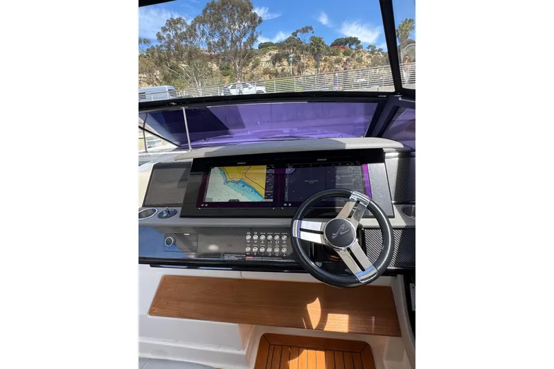 Slide: The Image of Cockpit of 2021 Sea Ray SLX 400 with navigation display and steering wheel. - 28