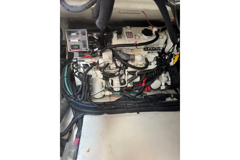 Slide: The Image of Engine compartment of a 2021 Sea Ray SLX 400 boat, showcasing wiring and components. - 32