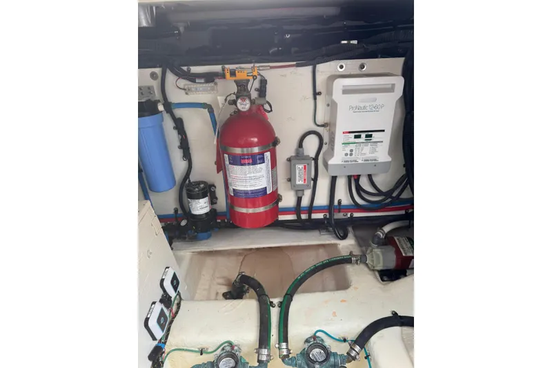 Slide: The Image of Engine compartment of 2021 Sea Ray SLX 400 with fire extinguisher and electrical components. - 33