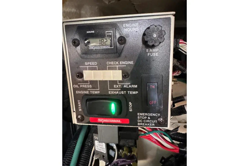 Slide: The Image of Control panel of a 2021 Sea Ray SLX 400 boat, showing engine hours and switches. - 34