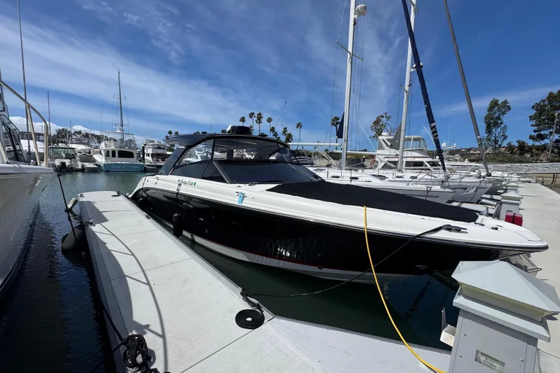 Slide: The Image of 2021 Sea Ray SLX 400 docked at marina under clear blue sky. - 6