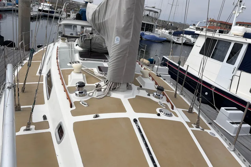 Slide: The Image of Sailboat Nordic 44, 1986 model, docked at marina with covered mast and clean deck. - 12