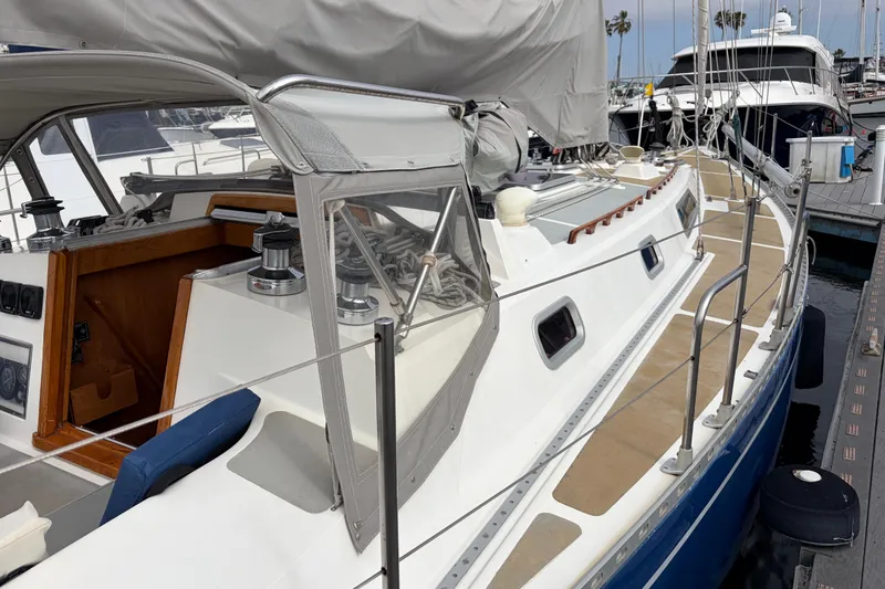 Slide: The Image of Tall mast of 1986 Nordic 44 sailboat against a blue sky with clouds. - 15