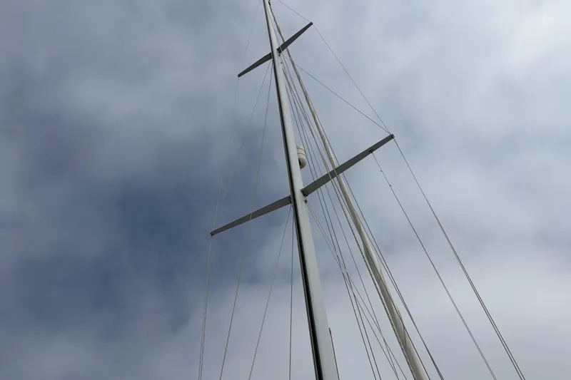 Slide: The Image of Tall mast of a 1986 Nordic 44 sailboat against a cloudy sky. - 16