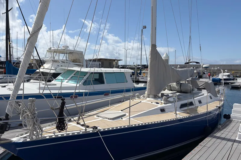 Slide: The Image of Sailboat docked at marina, Nordic 44 model, 1986, under clear blue sky. - 2
