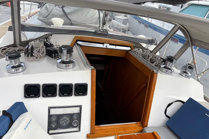 Slide: The Image of Cockpit of 1986 Nordic 44 sailboat with winches, ropes, and navigation instruments. - 20