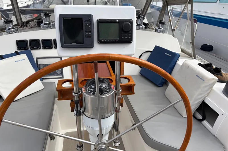 Slide: The Image of 1986 Nordic 44 yacht kitchen with wooden cabinets, stove, double sink, and spice rack. - 27