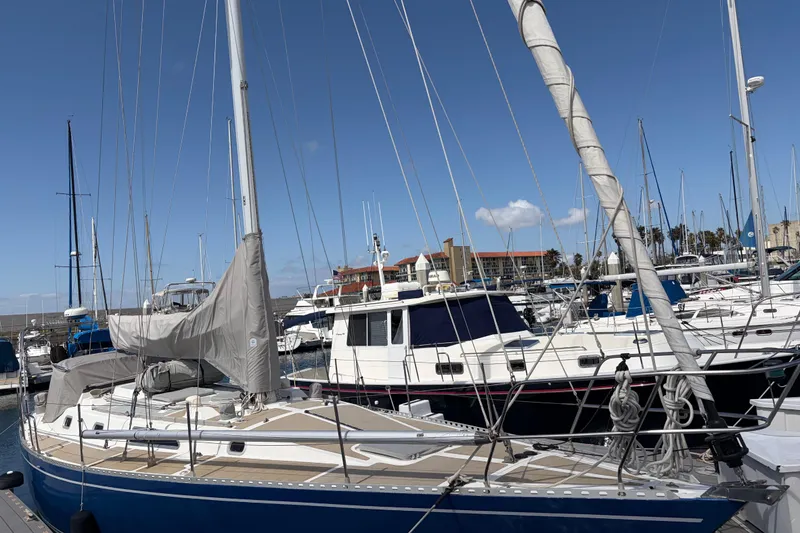 Slide: The Image of 1986 Nordic 44 sailboat docked in a marina under clear blue skies. - 3