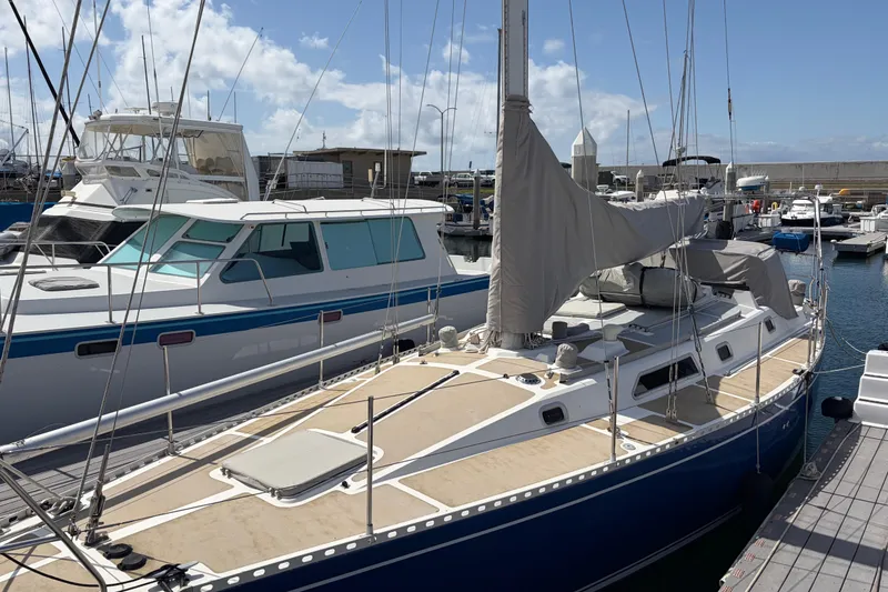 Slide: The Image of Sailboat docked at marina, Nordic 44 model, 1986, with covered sails and clear sky. - 5