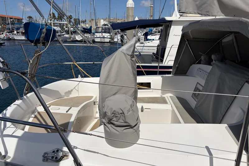 Slide: The Image of Sailboat Nordic 44, 1986 model, docked at marina with covered cockpit area. - 6