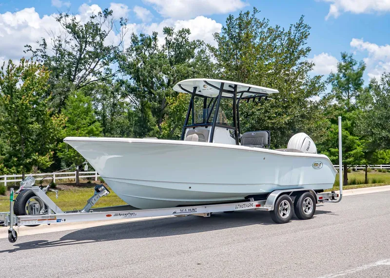 The Image of 2026 Sea Hunt Ultra 229 boat on trailer, parked outdoors. - 1