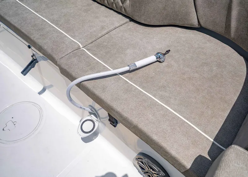 Slide: The Image of Interior of 2026 Sea Hunt Ultra 229 with bench seat and hose. - 17