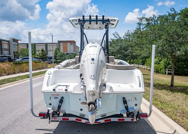 Slide: The Image of Rear view of a Sea Hunt Ultra 229 boat, model year 2026, on a trailer. - 4
