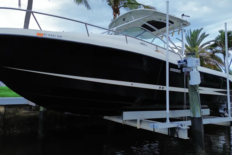 Slide: The Image of 2006 Hydra-Sports Vector 2900 VX boat docked near palm trees. - 10