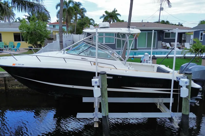 Slide: The Image of 2006 Hydra-Sports Vector 2900 VX boat docked near waterfront home with palm trees. - 11
