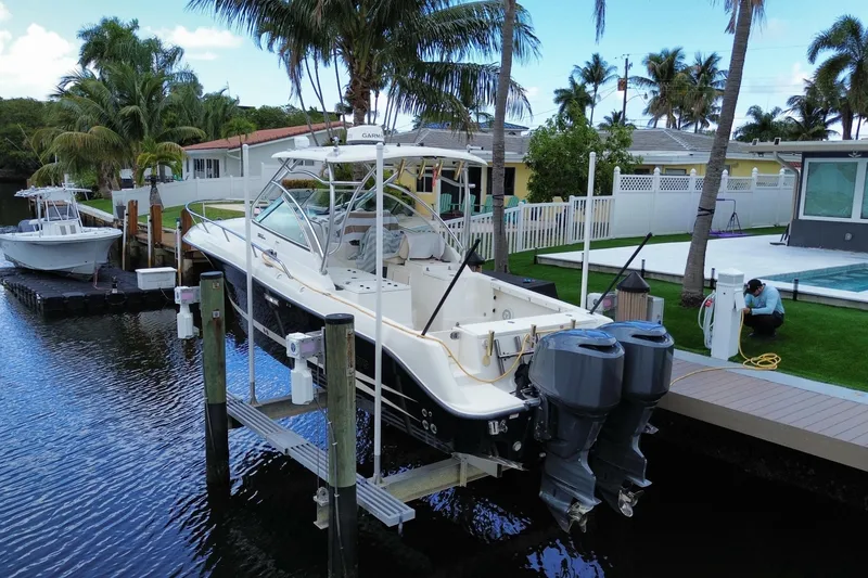 Slide: The Image of 2006 Hydra-Sports Vector 2900 VX boat docked by waterfront home with palm trees. - 15