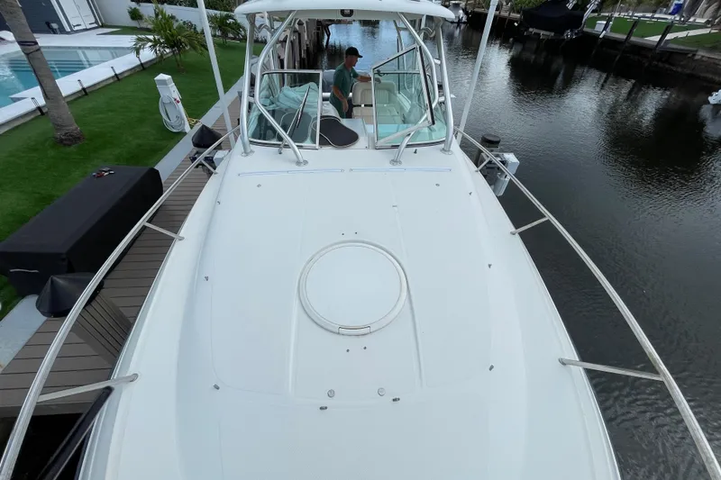 Slide: The Image of 2006 Hydra-Sports Vector 2900 VX boat docked by a canal, featuring spacious deck and sleek design. - 19