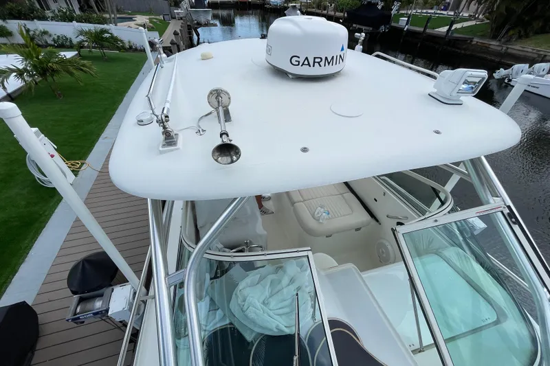 Slide: The Image of 2006 Hydra-Sports Vector 2900 VX boat with Garmin equipment, docked near lush greenery. - 21