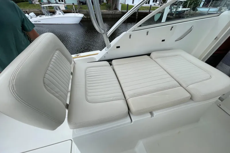 Slide: The Image of 2006 Hydra-Sports Vector 2900 VX boat with white cushioned seating, docked by the water. - 29