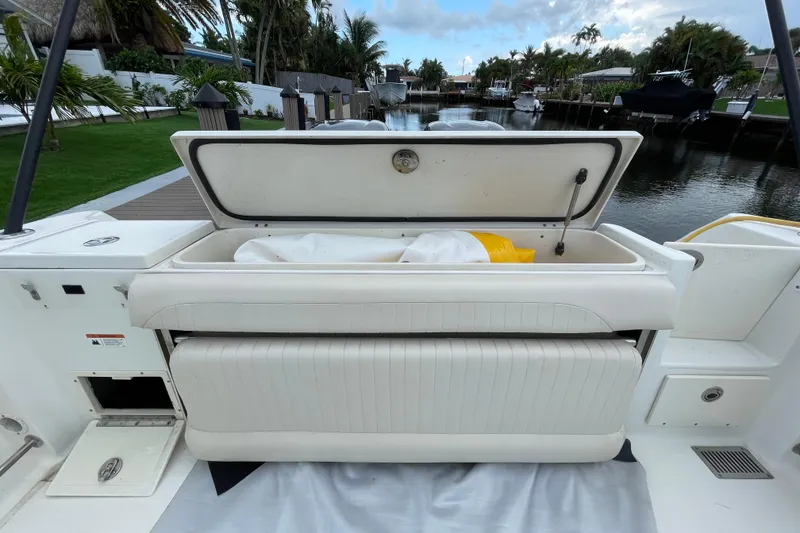 Slide: The Image of 2006 Hydra-Sports Vector 2900 VX boat with open storage compartment by a serene waterfront. - 31