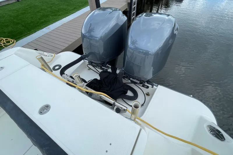 Slide: The Image of 2006 Hydra-Sports Vector 2900 VX boat with dual outboard motors docked by water. - 33