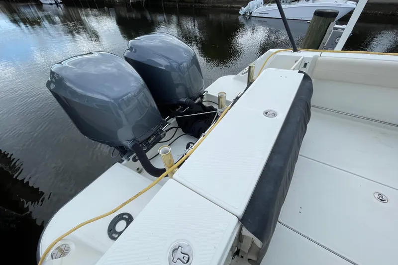 Slide: The Image of 2006 Hydra-Sports Vector 2900 VX boat with dual outboard engines docked by the water. - 34