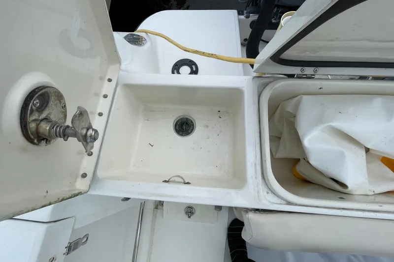 Slide: The Image of 2006 Hydra-Sports Vector 2900 VX boat storage compartments with open lids and visible hardware. - 35