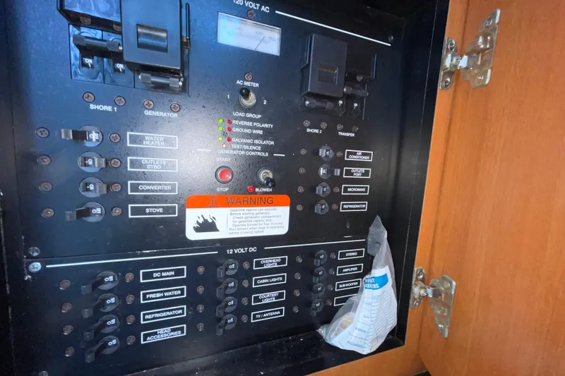 Slide: The Image of Electrical panel of a 2006 Hydra-Sports Vector 2900 VX boat with various switches and warnings. - 38