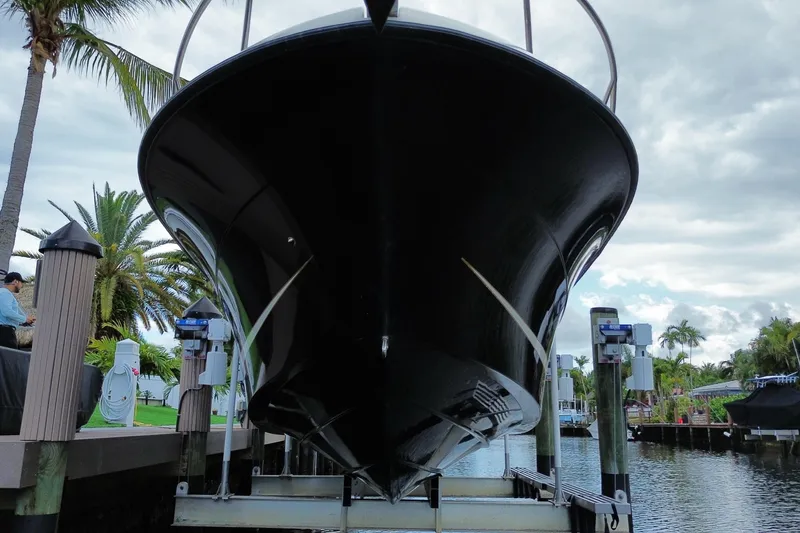 Slide: The Image of 2006 Hydra-Sports Vector 2900 VX boat on lift, surrounded by palm trees and waterway. - 9