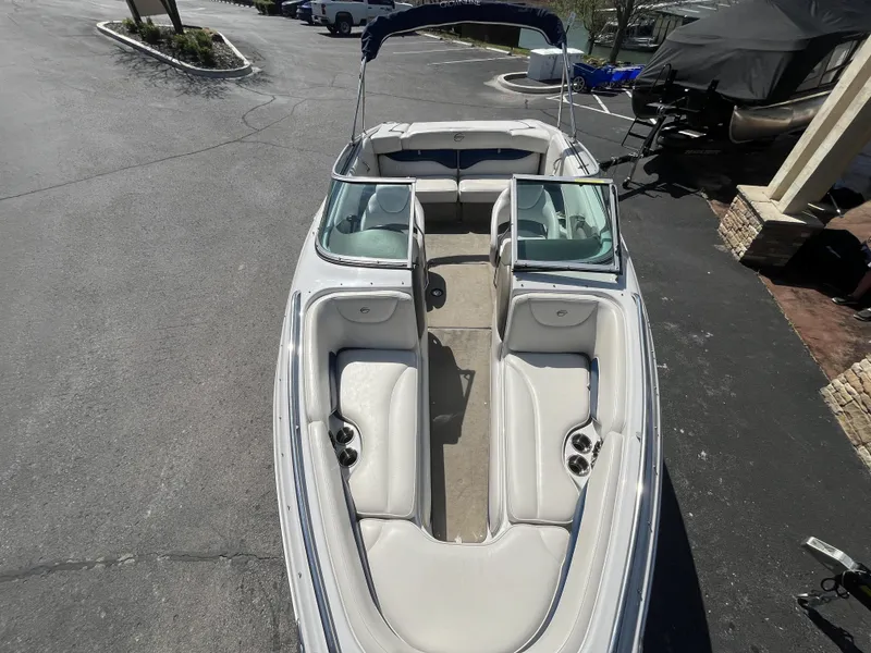 Slide: The Image of 2008 Crownline 23 SS boat with open cabin on parking lot. - 23