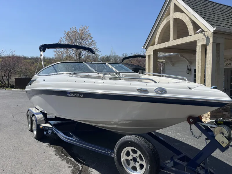 Slide: The Image of 2008 Crownline 23 SS boat on trailer in front of building. - 4
