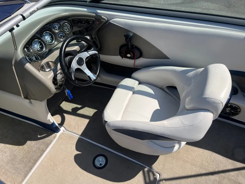 Slide: The Image of Interior of a 2008 Crownline 23 SS boat with steering wheel and seat. - 49