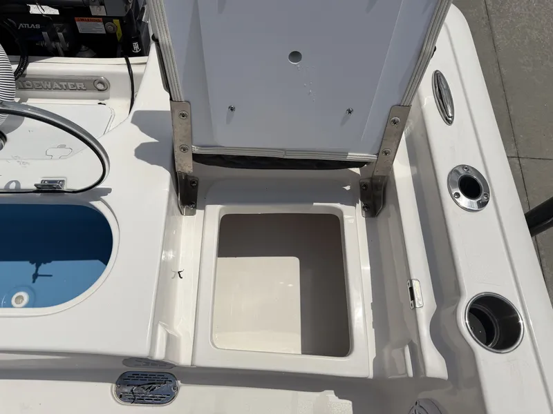 Slide: The Image of Tidewater 2110BMT 2026 boat with open storage compartment and fishing rod holders. - 14
