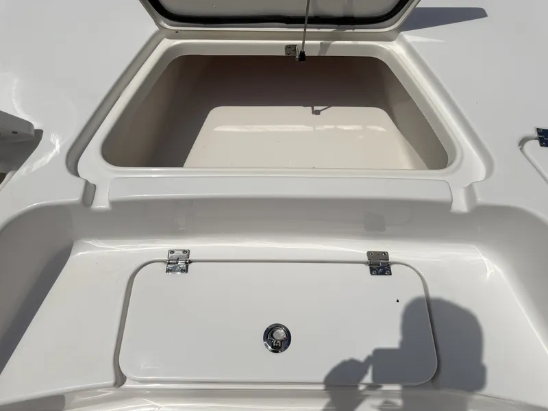 Slide: The Image of Open storage compartment on a 2026 Tidewater 2110BMT boat. - 22