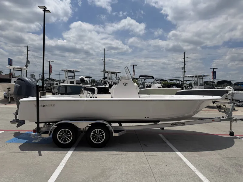 Slide: The Image of 2026 Tidewater 2110BMT boat on trailer under cloudy sky. - 29