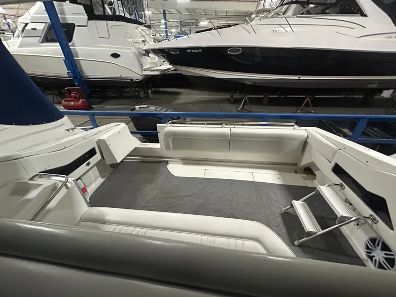 Slide: The Image of 1992 Sea Ray 370 Sundancer interior view in a marina setting. - 10
