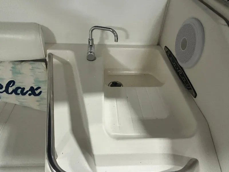 Slide: The Image of 1992 Sea Ray 370 Sundancer boat sink area with faucet and speaker. - 11